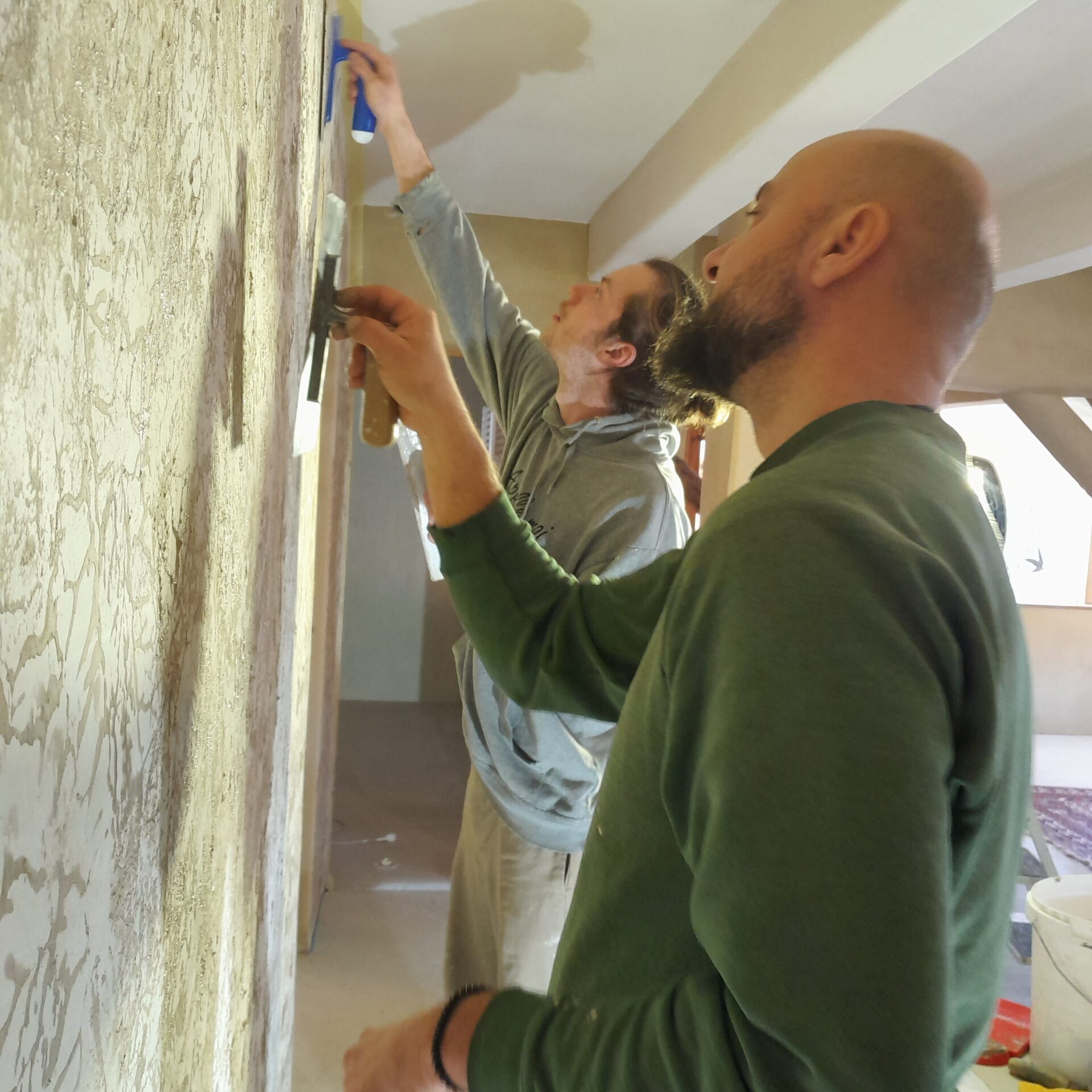 Janez & volunteer applying decorative clay